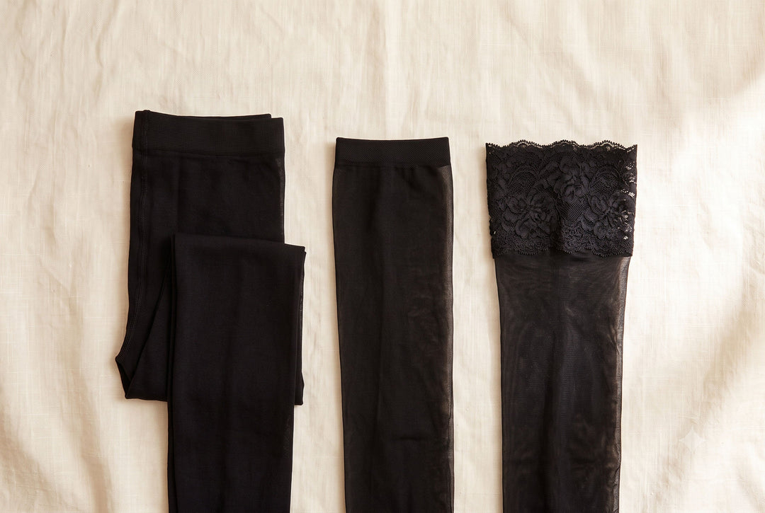 Black tights, stockings and lace-top hold-ups laid side by side showing the difference between the three hosiery types