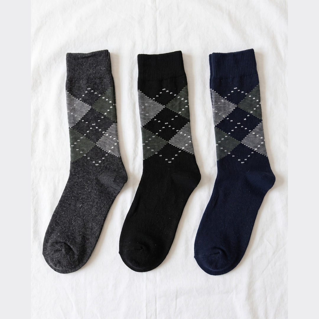 Louluu Argyle lambswool crew socks in charcoal, black and navy with grey and green diamonds — flat lay