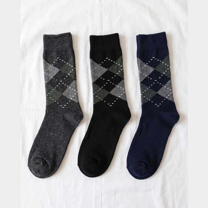 Louluu Argyle lambswool crew socks in charcoal, black and navy with grey and green diamonds — flat lay